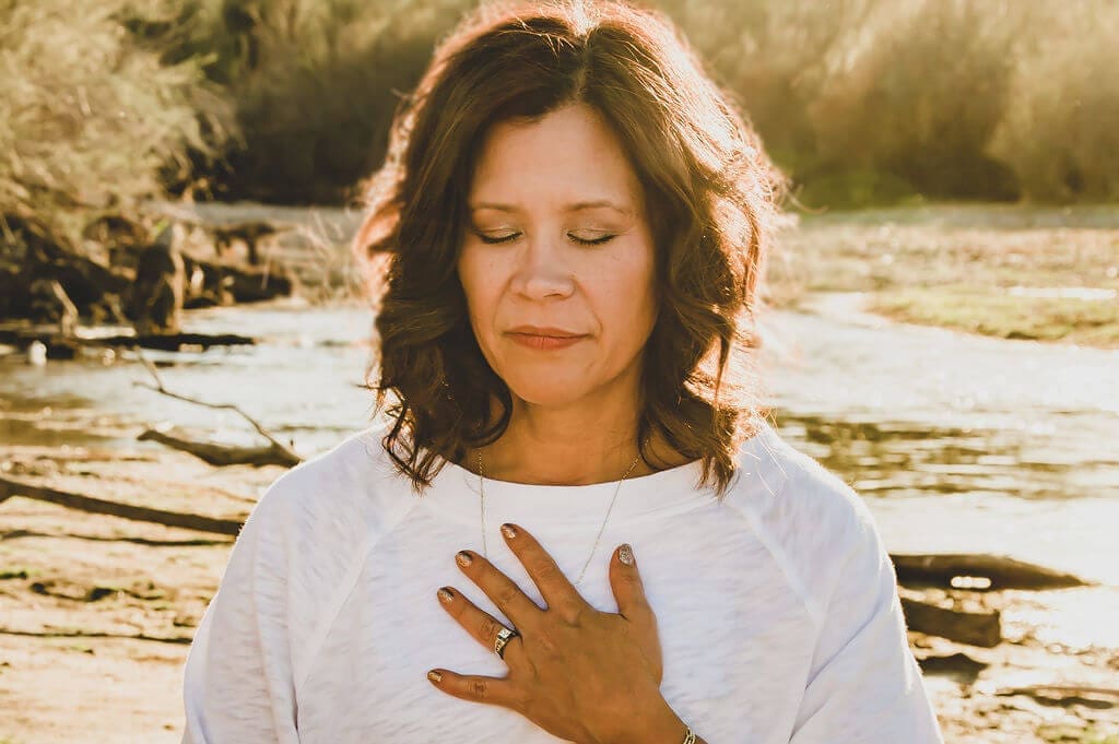 Liza Schrier outdoors in grounded, present stillness — reflecting the somatic, nervous system-informed healing approach at the heart of Bliss Body Breathe.
